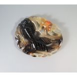 A Chinese Carved Agate Plaque decorated with a fancy goldfish