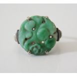 A Carved Jade Ring in a precious white metal setting, size L, 3 g