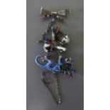 A Silver and Enameled Brooch in the form of St. George and The Dragon, c. 78 mm drop