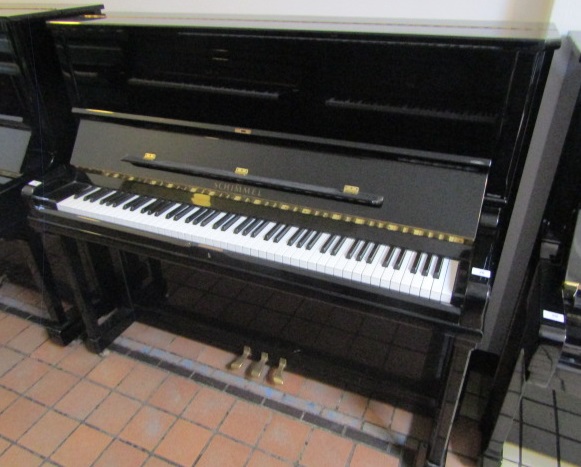 Schimmel (c1995) A traditional Model 128 upright piano in a bright ebonised case.