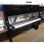 Yamaha A 126cm Model U2 upright piano in an ebonised case.