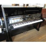 Yamaha A 121cm Model U1 upright piano in an ebonised case.