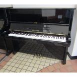 Yamaha A 126cm Model U2 upright piano in an ebonised case.
