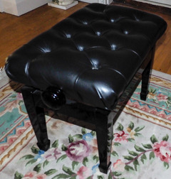 Piano Stool A concert adjustable piano stool in a bright ebonised finish with button leather top.