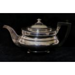 A George III silver teapot, London 1813, the body with bright cut engraving,