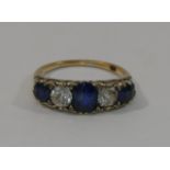 An 18 carat gold sapphire and diamond five stone carved half hoop ring,