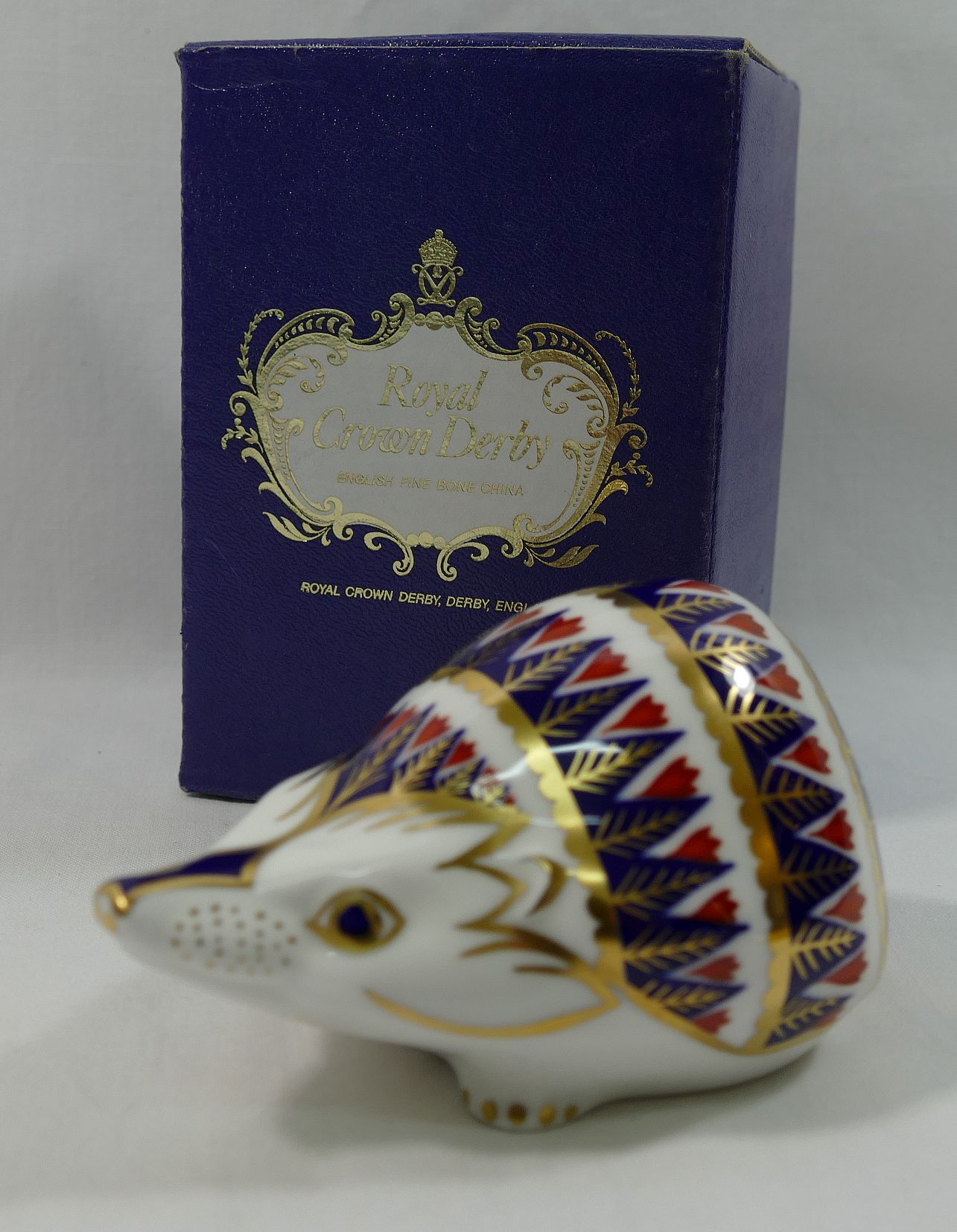A Royal Crown Derby hedgehog paperweight, with gold stopper, 5.