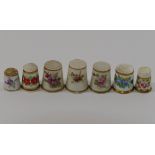 Seven 19th century and later bone china and porcelain thimbles,