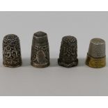 Four 19th century and later silver coloured metal thimbles including a filigree example,