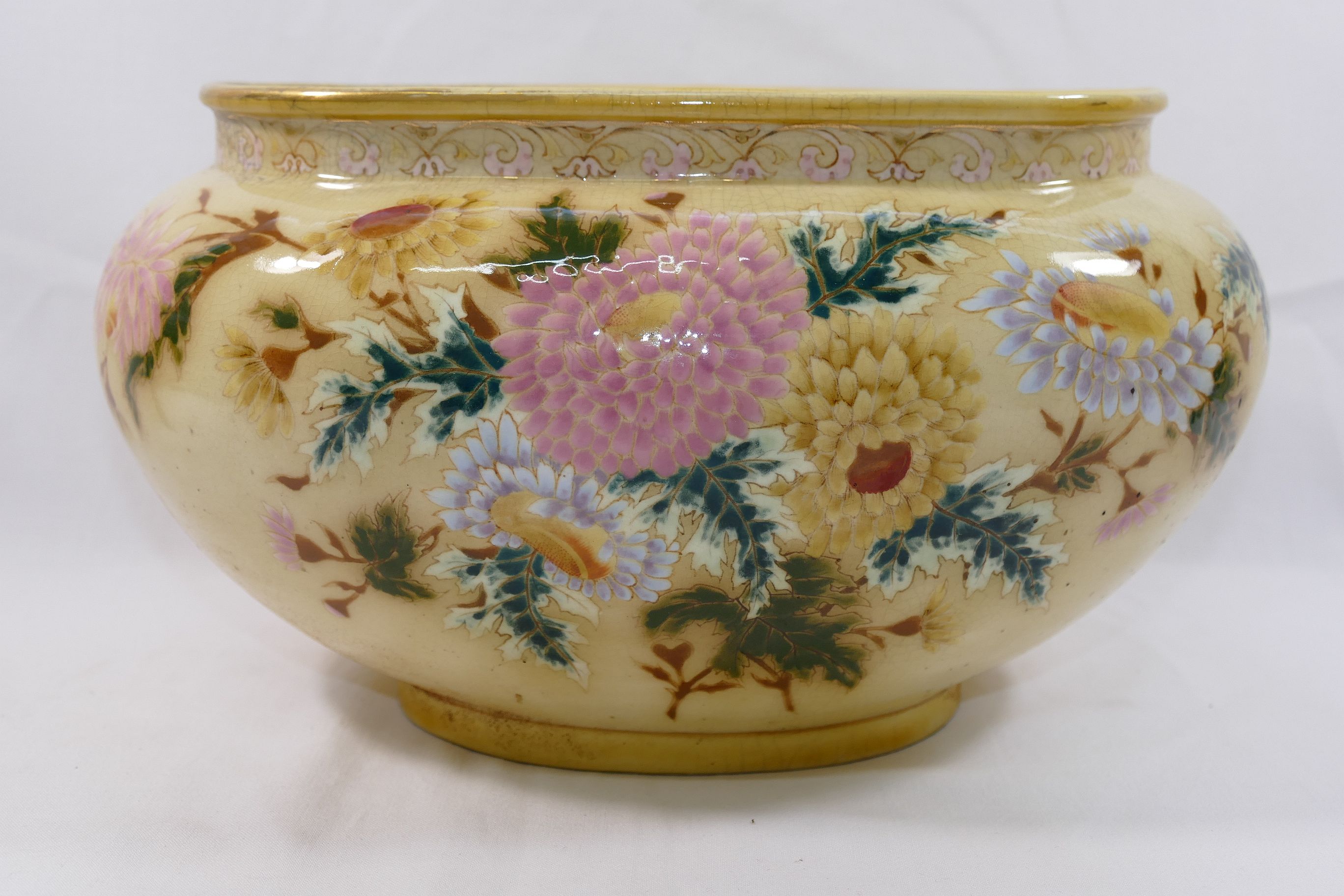 A Zsolnay oval jardinere, with yellow ground, hand painted in enamels with flowers,