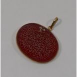 An oval carnelian panel engraved with Arabic text, housed in a gold pendant mount, 2.