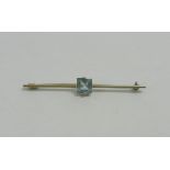 A 14 carat gold and aquamarine bar brooch,