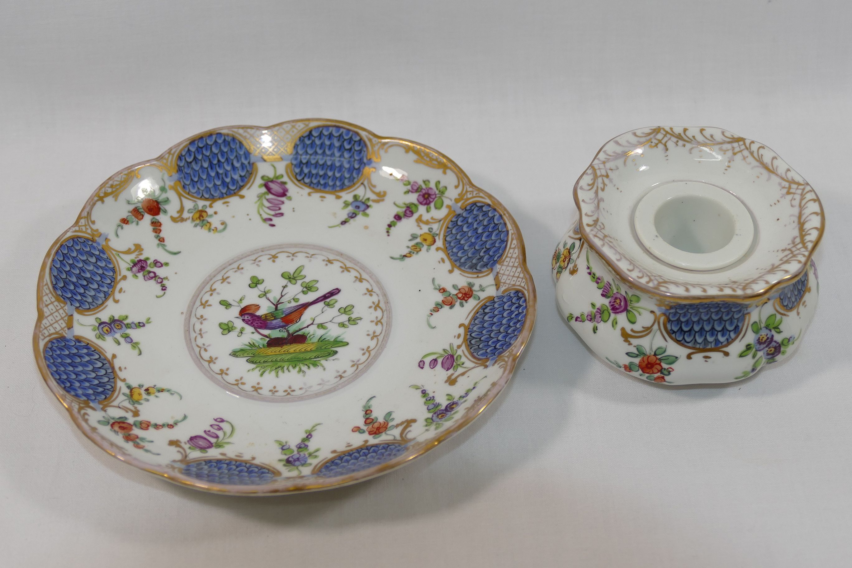 An early 20th century Dresden porcelain ink well and stand, decorated with floral sprigs,