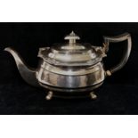 A George III silver teapot, London 1814, the body with reeded band, the rim with scroll,