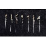 A set of seven silver coloured metal Chinoiserie design cocktail sticks, stamped 'Sterling',