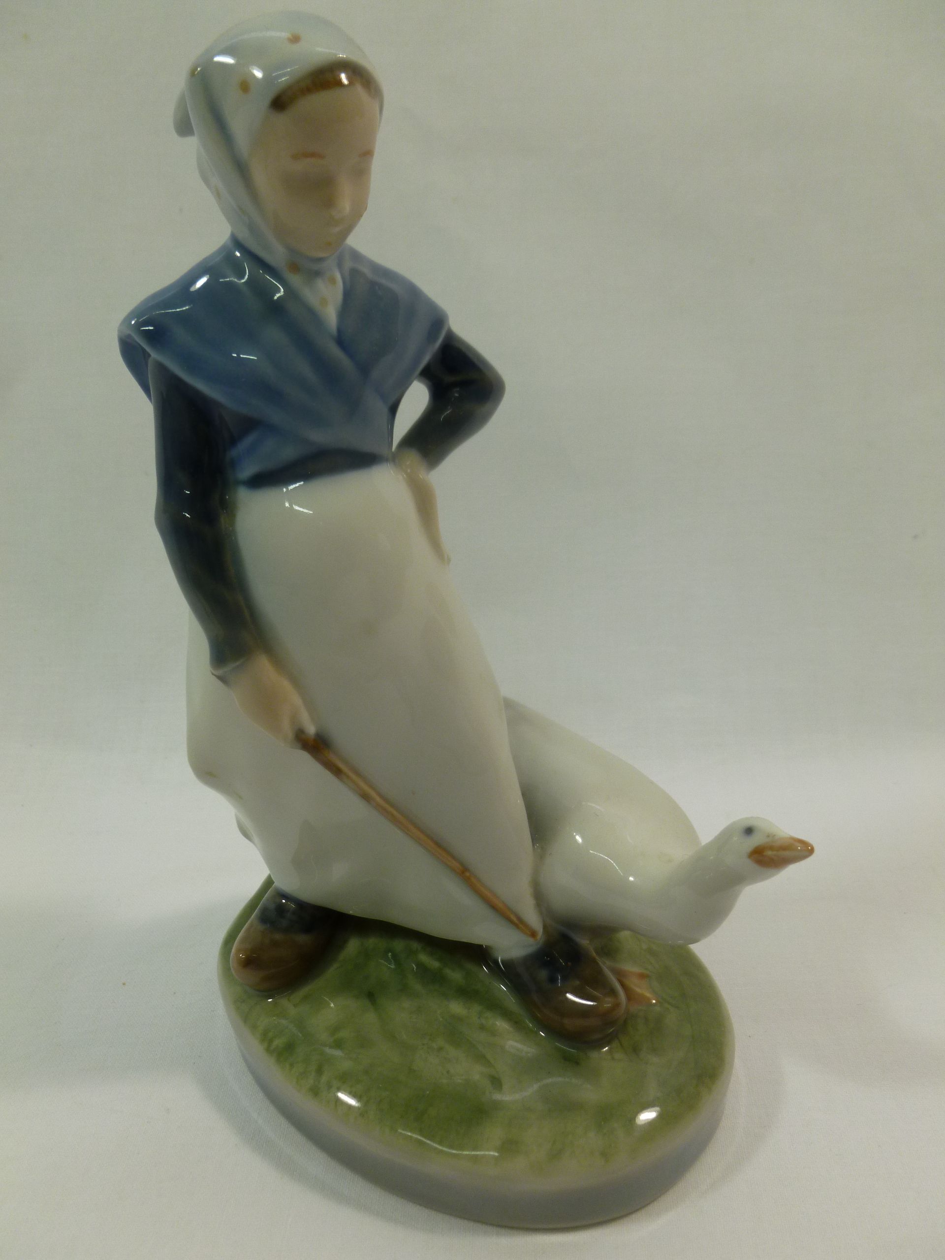 A Royal Copenhagen porcelain figure of a girl with a goose, 18.