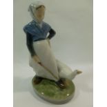 A Royal Copenhagen porcelain figure of a girl with a goose, 18.