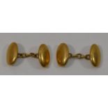 A pair of plain oval gold cuff links, stamped '18CT', combined weight 10.