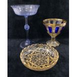 A 19th century Bohemian blue flashed panel cut and gilt decorated wine glass, 11.