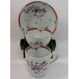 An 18th century porcelain trio, possibly Newhall, decorated with flowers in famille rose palette,