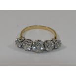 An 18 carat gold five stone ring, the round brilliant cut diamond simulants in white claw setting,