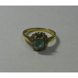 An 18 carat gold blue zircon and diamond circular cluster ring,