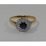 A modern sapphire and diamond circular cluster ring,