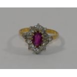 A ruby and diamond oval cluster ring,