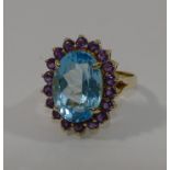 A modern 14 carat gold topaz and amethyst oval cluster ring, the oval mixed cut topaz, 1.8cm x 1.