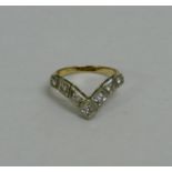 A diamond set wishbone ring, the seven round brilliant cut diamonds each approximately 0.