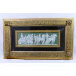 A Wedgwood green jasperware panel, depicting classical figures, chariots and horses, 9cm x 28.