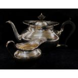 An early 20th century silver teapot and cream jug, Sheffield 1916,