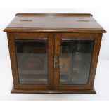 An early 20th century oak smoker's cabinet,