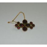 A Georgian Bohemian garnet and gold brooch, the ten stones in closed foil backed settings,