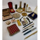 A collection of compacts, pens and lighters and other items comprised of a Ronson, Coty, Stratton,