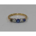 An 18 carat gold and platinum diamond and sapphire five stone ring (one sapphire lacking),