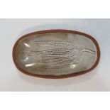 A David Leach small oval pottery dish, decorated with seed pods,