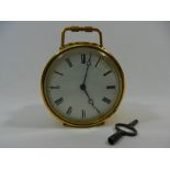 A circular gilt brass cased mantle clock, the white enamel face with Roman numerals, 9cm diameter,