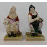 A pair of Staffordshire pottery seated f