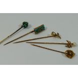 A collection of five gold Victorian stick pins with turquoise and seed pearl set tops