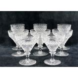 Eight hobnail cut glasses, a matching claret jug and decanter (at fault),