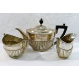 An Edwardian silver boat-shaped teapot, with ebonised handle and knop,