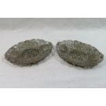 A pair of Chinese silver coloured metal oval filigree dishes, 14cm x 10.5cm, combined weight 3.