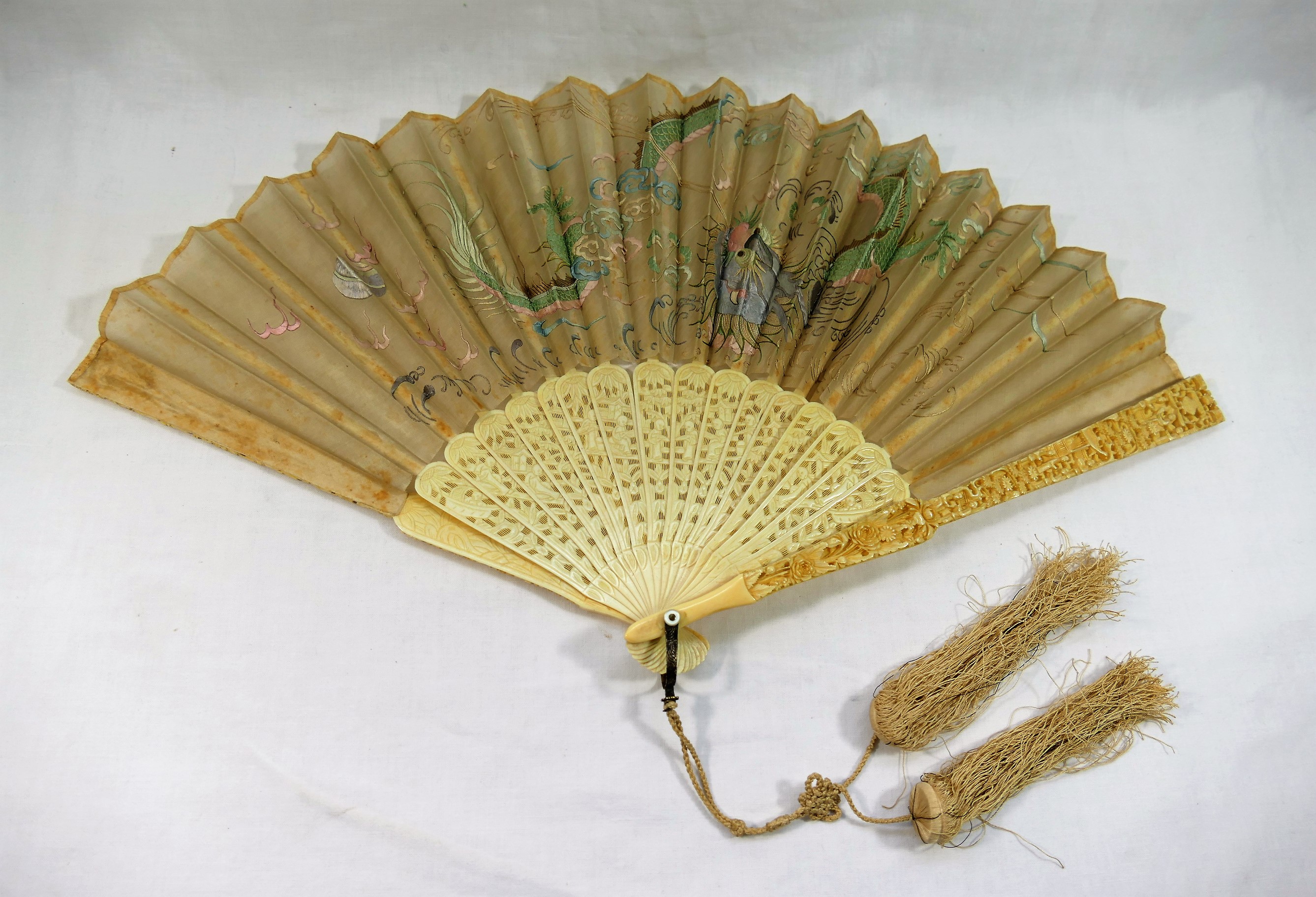 A late 19th century Chinese fan, with embroidered dragon decoration,
