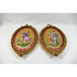 A pair of 19th century Sevres style oval porcelain plaques each hand painted with a classical