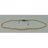 A small early 20th century potentially natural (untested) pearl necklace with diamond clasp,