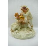 A Royal Worcester porcelain figural spill holder by James Hadley modelled as a boy and a girl