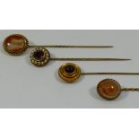 Three Victorian gold stick pins set with agate, garnet, amethyst and seed pearl,