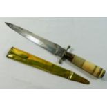 A 19th century dagger with turned horn and bone handle and brass sheath,