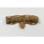 A 9 carat gold fancy gate link bracelet, with heart shaped padlock clasp stamped '9CT', 23mm wide,